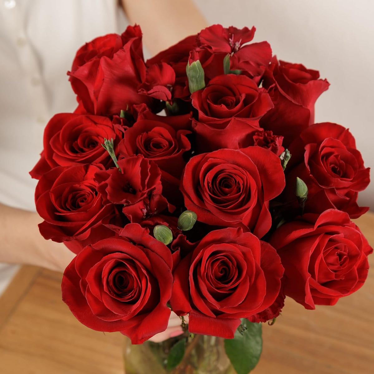 Fresh red rose bouquet on a wooden table