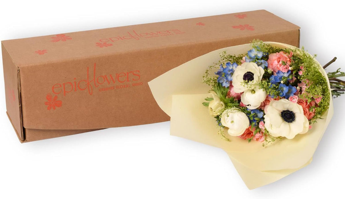Fresh bouquet of roses and mixed flowers in a glass vase