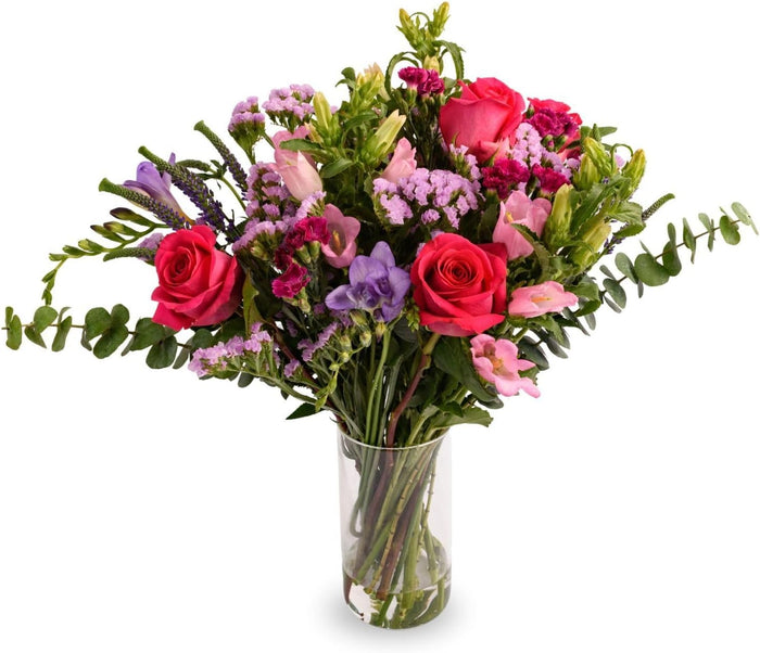 Lavender Bliss bouquet with lavender roses and freesia in a glass vase