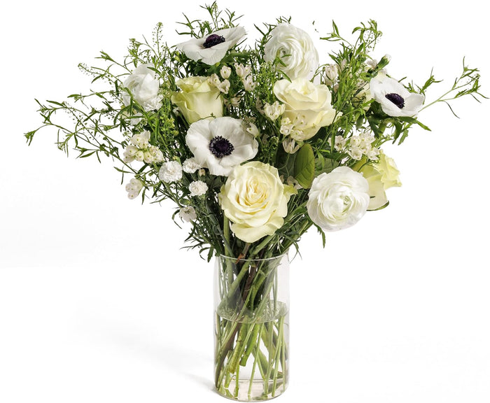 White Whisper bouquet with white roses and anemones in a glass vase