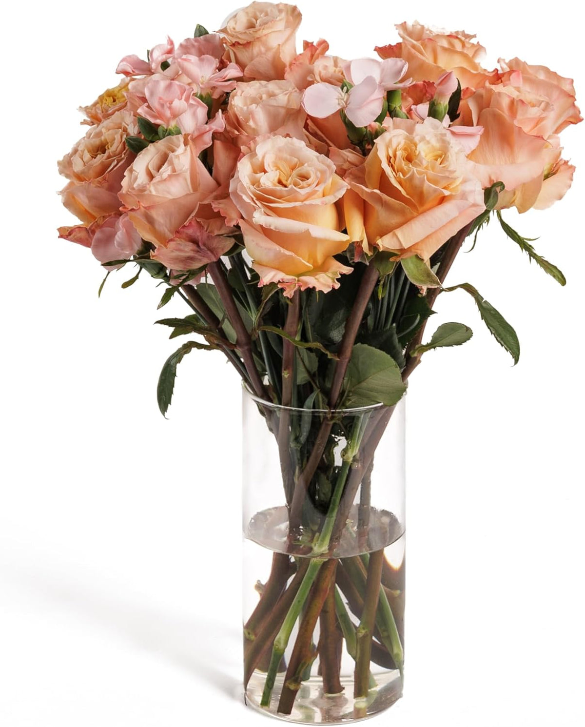 Peach Whisper bouquet of peach roses in a glass vase