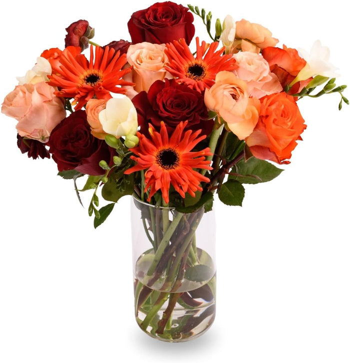 The Admire Bouquet with red roses and orange gerberas in a glass vase